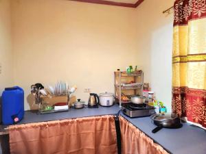 a kitchen with a counter top with pots and pans at Joi's Entire House @ Lessandra Gran Europa Lumbia in Cagayan de Oro