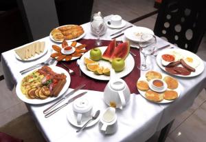 un tavolo bianco con piatti di cibo sopra di Leawood Hotel a Lekki