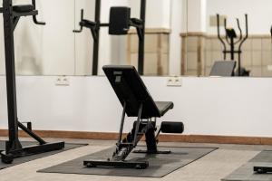 a gym with a black chair on a rug at DWO Finca Los Abetos in Córdoba
