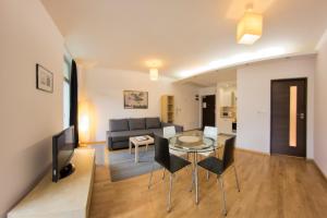 a living room with a table and a couch at Yourplace Central Apartments in Kraków