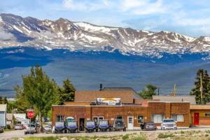 a building with parked cars in front of a mountain at 8 Private room in heart of Leadville dog friendly in Leadville