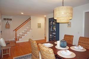 a dining room with a wooden table and chairs at Wedgewood Cottage in Barnstable
