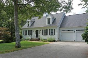a white house with a garage at Wedgewood Cottage in Barnstable