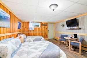 a bedroom with a bed and a tv and a table at 1 Spacious Private Room Dog Friendly Leadville in Leadville