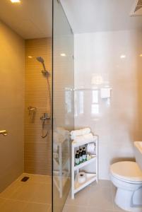 a bathroom with a shower and a toilet at Tranquil Manor at Uptown BGC in Manila