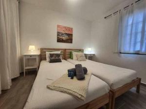 a bedroom with two beds and a window at Happy House Puerta del Sol in Caleta De Fuste