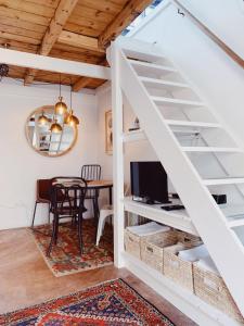 a room with a loft bed and a dining room at Cottage On Windsor in Cape Town