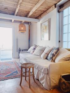a living room with a large couch and a table at Cottage On Windsor in Cape Town