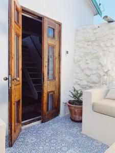 an open wooden door in a room with a plant at Cottage On Windsor in Cape Town