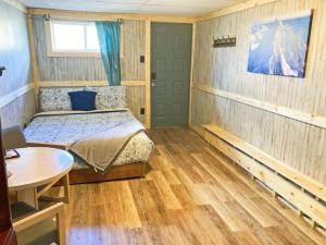 a bedroom with a bed and a table in it at 3 Private Room in Motel Dog Friendly Leadville in Leadville