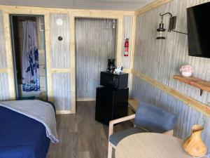 a bedroom with a bed and a chair and a television at 3 Private Room in Motel Dog Friendly Leadville in Leadville
