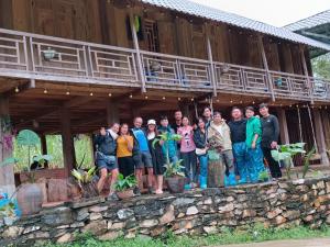 a group of people standing in front of a building at MyMy eco Homestay in Làng Cac