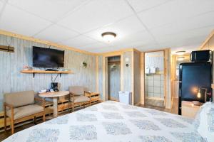 a bedroom with a bed and a table and a tv at 2 Dog Friendly Private Cozy Room in Leadville in Leadville