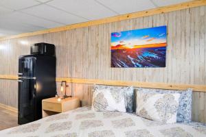 a bedroom with a bed and a refrigerator at 2 Dog Friendly Private Cozy Room in Leadville in Leadville