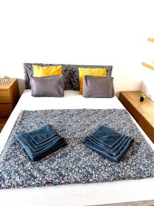 ein Bett mit zwei blauen Kissen darauf in der Unterkunft Central apartment with balcony in Budapest