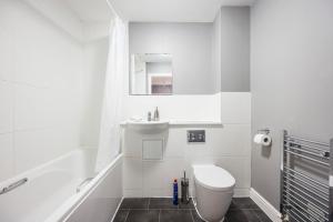 a white bathroom with a toilet and a sink at Beautiful Large rooms in Ashford in Willesborough