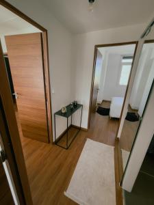 a room with a door and a mirror and a bed at Appartement Cosy & Connecté à 15 min de Paris in Soisy-sous-Montmorency