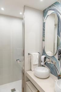 a bathroom with a sink and a mirror at Napoli Suite Station in Naples +54 photos
