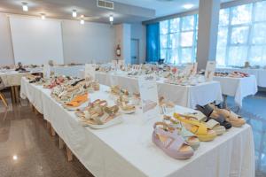 a large room with tables with shoes on them at Hotel Amico in Citta' Sant'Angelo