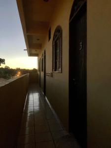 an empty hallway of a building with the sunset in the background at Trancoso Suíte Center Braga in Trancoso