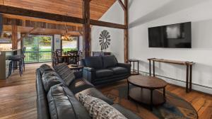 a living room with a leather couch and a table at Orsinis At Mad House condo in Warren