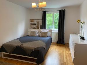 Schlafzimmer mit einem Bett und einem Fenster in der Unterkunft Fin lägenhet. Gångavstånd till Strömstads centrum. in Strömstad
