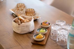 a table with a bag of food and bowls of food at Waldhotel und Restaurant Zeitreise in Bramsche