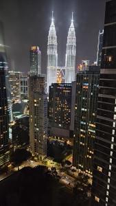 a view of a city at night with tall buildings at 8 Kia Peng Suites KLCC by Luna in Kuala Lumpur