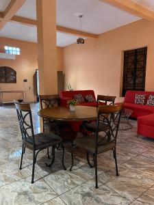 Una sala de estar con una mesa y sillas y un sofá. en Hotel y Restaurante La Perla, Cacaopera, Morazan, El Salvador, en Cacaopera