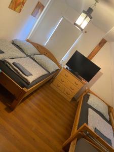 a bedroom with a bunk bed and a desk with a laptop at Zirndorf Gästehaus in Zirndorf