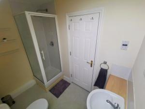 a bathroom with a shower and a toilet and a sink at No 23- Large Spacious 3 Bed Home - Parking & WiFi in Nantwich