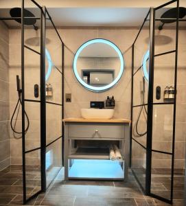 a bathroom with a sink and a mirror at Pinnacle Suites Hotel in Cowes