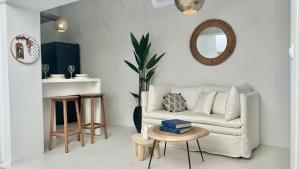 a living room with a white couch and a table at Zina Apartment à Sidi Bou Saïd in Sidi Bou Saïd