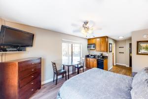 a bedroom with a bed and a kitchen with a table at Carriage House #215 in Park City