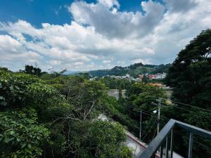 a view of a city from a balcony with trees at Urban Shelter, El Dorm. in Guatemala