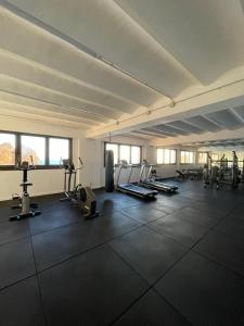 a large room with a gym with treadmills and machines at Cap Sa Sal suites -Apartament Begur - Costa Brava in Begur