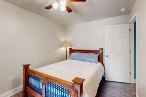 a bedroom with a bed and a ceiling fan at Lazy River, Lazy Days in Shoreline Park