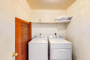 a small kitchen with two washers and a refrigerator at Killeen Apartments, Multiple Units in Killeen