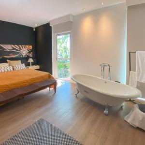 a bathroom with a bed and a tub in a room at Rio Holiday Boutique Hotel in Niterói