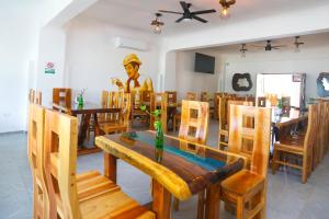 a statue in a restaurant with a table and chairs at Hotel Maria de Lourdes in Cancún