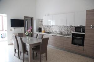 a kitchen with a dining room table and chairs at Casa corrado in Sarno