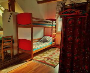 a room with two bunk beds and a chair at U WOJTUSIA in Czarny Dunajec