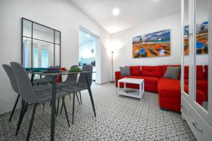 een woonkamer met een rode bank en een tafel bij Casa Ingenio - Exclusive Facility in Ingenio