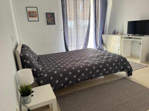 a small bed in a room with a window at WINDSOR PLACE APARTMENT - SELF CHECKIN with CODE in Athens