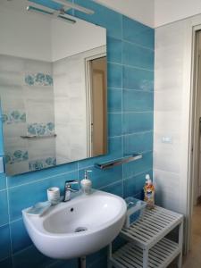a bathroom with a white sink and a mirror at Onde Salentine Deluxe in Casalabate +128 photos