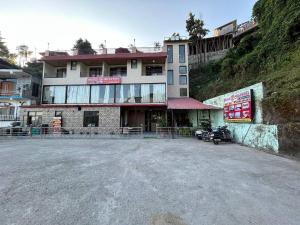 a building with a motorcycle parked in front of it at Hotel 7 Heavens in Mussoorie