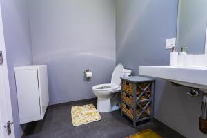 a bathroom with a toilet and a sink at 1- Bdr Condo w Patio Close to the beach in Long Beach +23 photos