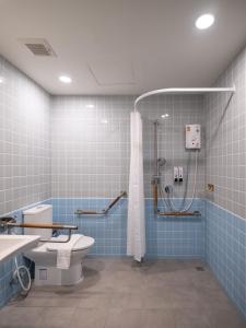 a bathroom with a shower and a toilet and blue tiles at Bedtime storeys near ICON SIAM in Bangkok +97 photos