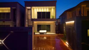a house with a bench in the middle of a building at Mariaddo homes in Accra