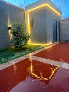 a house with a red floor and lights on it at Mariaddo homes in Accra